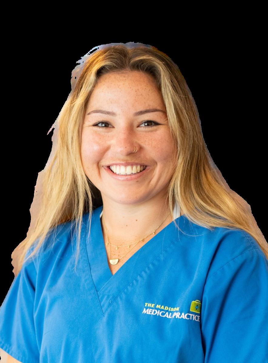 Female healthcare professional in blue medical scrubs smiling at camera